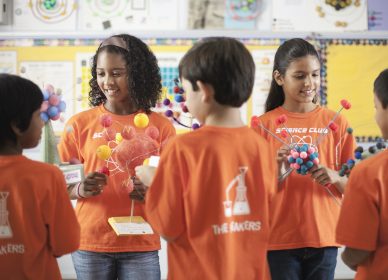 A group of children in Science Club, holding molecular models