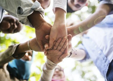 Group of diverse youth hands joined